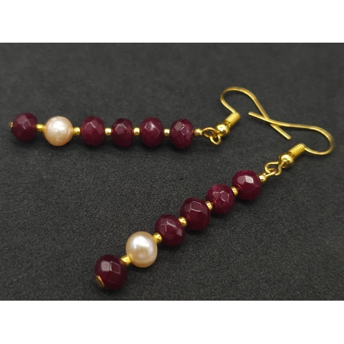 141 - A three strand necklace with multifaceted rubies and genuine pink pearls with a complimenting facete... 