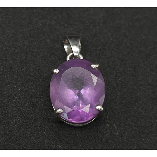 475 - A 9K White Gold Amethyst Pendant. Oval shaped amethyst set in white gold. 1.81g total weight.