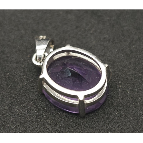 475 - A 9K White Gold Amethyst Pendant. Oval shaped amethyst set in white gold. 1.81g total weight.