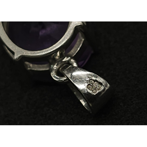 475 - A 9K White Gold Amethyst Pendant. Oval shaped amethyst set in white gold. 1.81g total weight.