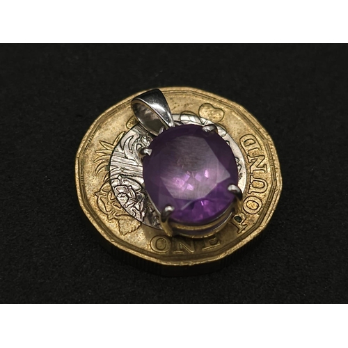 475 - A 9K White Gold Amethyst Pendant. Oval shaped amethyst set in white gold. 1.81g total weight.