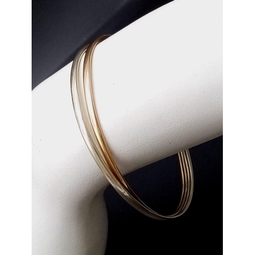 617 - A 9ct Yellow and White Gold Interlocking Wedding Bangle. 6.77g weight.