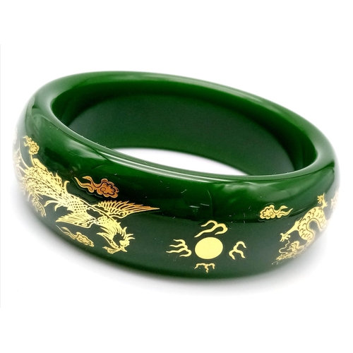 258 - A fashionable, Chinese, spinach green bangle with two gilded celestial dragons, offering glamour and... 