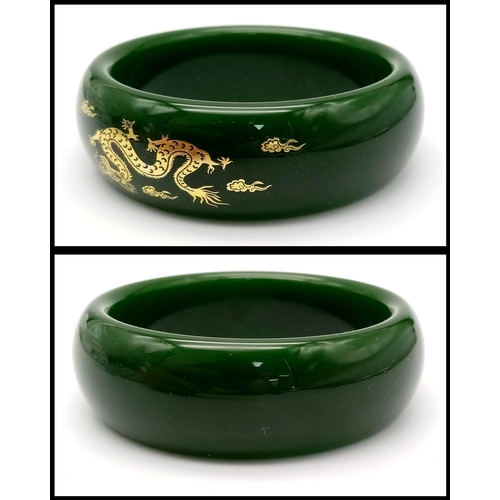 258 - A fashionable, Chinese, spinach green bangle with two gilded celestial dragons, offering glamour and... 