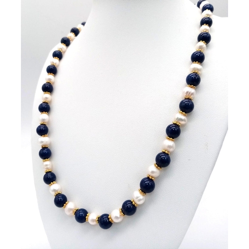 408 - A Cultured Pearl and Lapis Lazuli Matinee Length Necklace. 8mm lapis and pearls. Gilded spacers and ... 