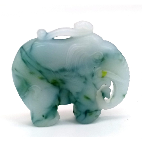 466 - A Chinese Hand-Carved Green and White Jade Elephant Pendant or Figurine. 5cm x 4cm