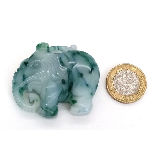 466 - A Chinese Hand-Carved Green and White Jade Elephant Pendant or Figurine. 5cm x 4cm