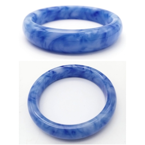 643 - A Blue and White Jade Decorative Swirl Bangle. 6cm inner diameter. 14mm width.