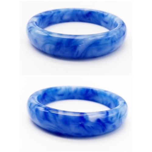 643 - A Blue and White Jade Decorative Swirl Bangle. 6cm inner diameter. 14mm width.