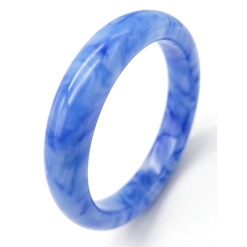 643 - A Blue and White Jade Decorative Swirl Bangle. 6cm inner diameter. 14mm width.