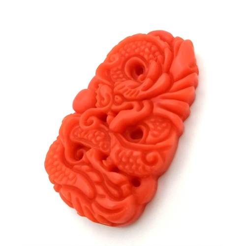 685 - A Chinese Red Jade Decorative Dragon Pendant. 5cm x 3cm.