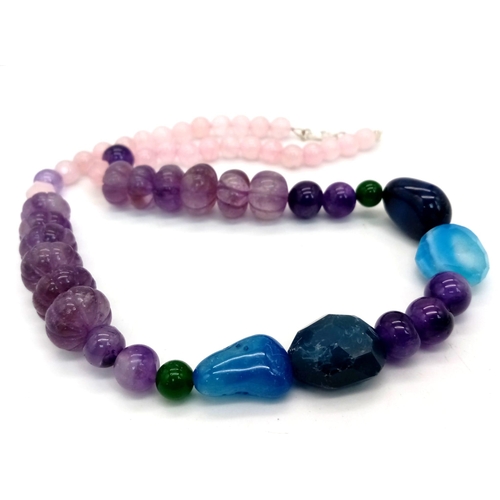 725 - A Multi-Gemstone Graduated Necklace. Amethyst, rose quartz, jade and agate. 46cm necklace length.