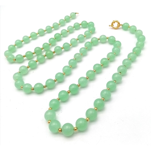 905 - A Matinee Length Pale Green Jade Beaded Necklace. 10mm beads. Gilded spacers and clasp. 90cm necklac... 