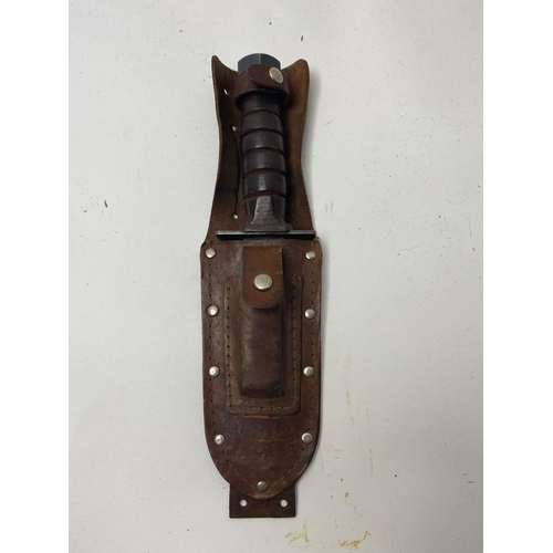 999 - An Ontario Airforce Survival Knife with Leather Scabbard and Sharpening Stone. 27cm length. ML 304