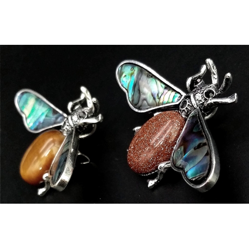 1062 - Two Gemstone Bee Brooches. Goldstone and Tigers Eye. Both with decorative shell wings. 5cm wingspan.... 