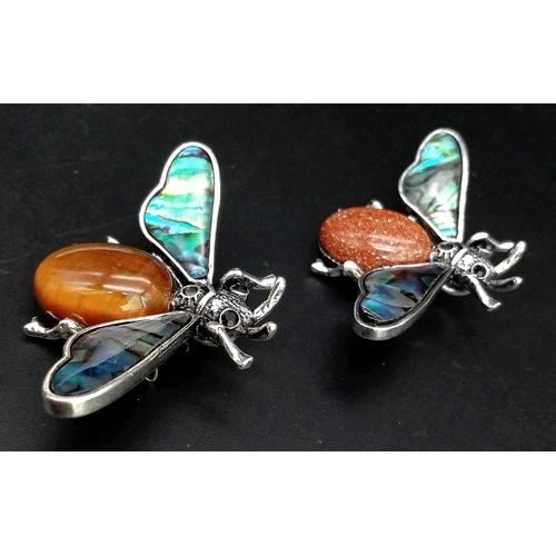 1062 - Two Gemstone Bee Brooches. Goldstone and Tigers Eye. Both with decorative shell wings. 5cm wingspan.... 