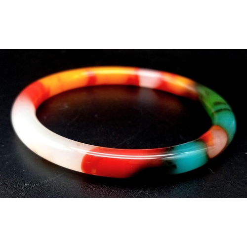 440 - A Multi-Coloured Jade Thin Bangle. An explosion of colour. 6cm inner diameter. 8mm width.