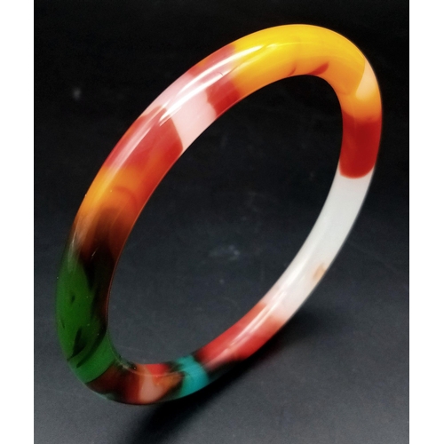 440 - A Multi-Coloured Jade Thin Bangle. An explosion of colour. 6cm inner diameter. 8mm width.