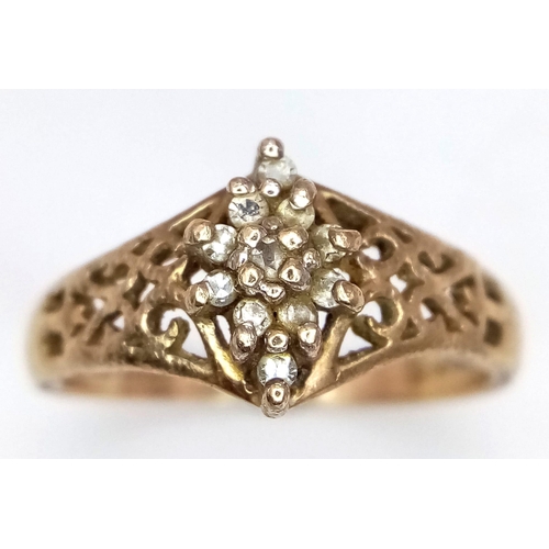 581 - An Antique 10K Gold Diamond Cluster Ring. Pierced decoartion at sides. Size L. 2.4g total weight.