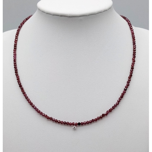 467 - A Red Ruby Small Bead Necklace with White Diamond Decoration with 14K Gold Clasp. 40cm.