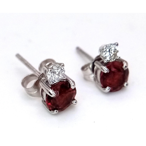 676 - A Pair of 14K White Gold Garnet and Diamond Earrings. 0.14ct diamonds.