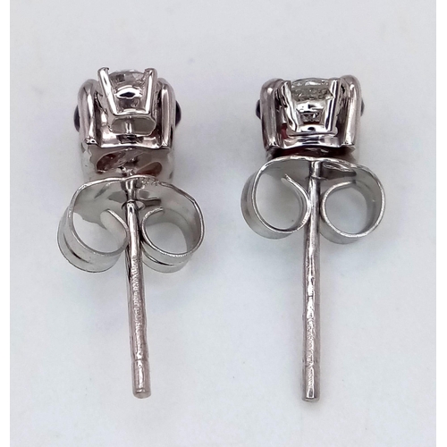 676 - A Pair of 14K White Gold Garnet and Diamond Earrings. 0.14ct diamonds.