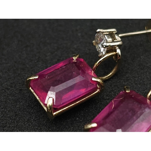 982 - A Pair of 14K Yellow Gold Ruby and Diamond Earrings. 0.24ctw of round cut diamonds. 2ctw of rectangu... 