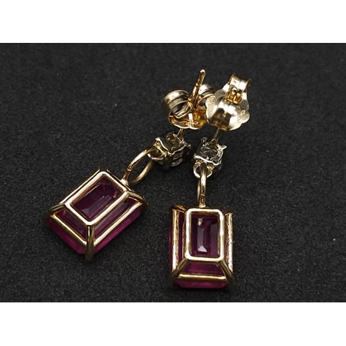 982 - A Pair of 14K Yellow Gold Ruby and Diamond Earrings. 0.24ctw of round cut diamonds. 2ctw of rectangu... 