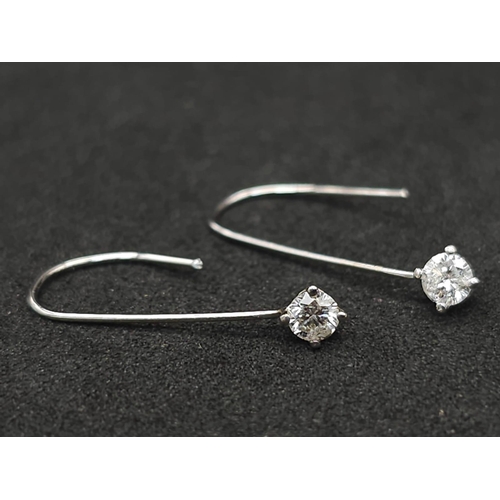 1034 - A Pair of 14K White Gold and Diamond Drop Earrings. 2cm drop. 0.18ctw.