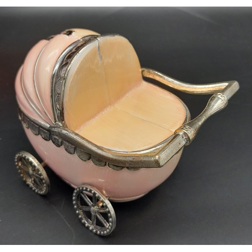 232 - A vintage, baby pram moneybox with over hundred halfpenny coins (various dates) inside. These coins ... 