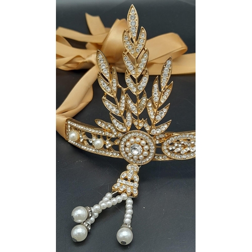 272 - A symbol of 30s “good times”, ART DECO tiara. Gilded with Austrian crystals complete with ribon.