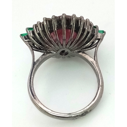 1108 - A Ruby Ring with Diamond Surround and Baguette Cut Emerald Accents, on 925 Silver. Ring size L. 5.25... 