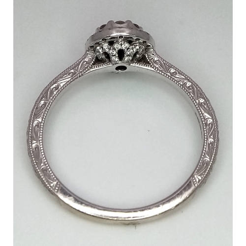 221 - An 18k white gold diamond halo cluster ring with engraved shoulders. 3.2g total weight.  Size N 1/2.... 