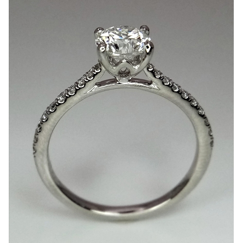 611 - A 950 Platinum Diamond Ring. Brilliant round cut VS1 diamond - 0.73ct with diamonds on shoulders - 0... 