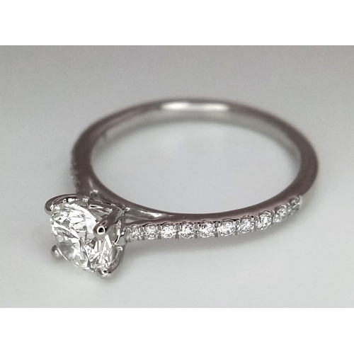 611 - A 950 Platinum Diamond Ring. Brilliant round cut VS1 diamond - 0.73ct with diamonds on shoulders - 0... 