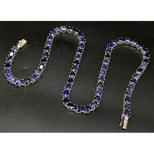 988 - A Blue Sapphire Gemstone Tennis Necklace on 925 Silver. 47.5cm in length, 38.4g total weight.