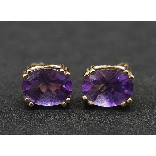 1023 - A pair of 9k yellow gold amethyst earrings. 1.8g total weight.(amethyst: 2.50ct total)