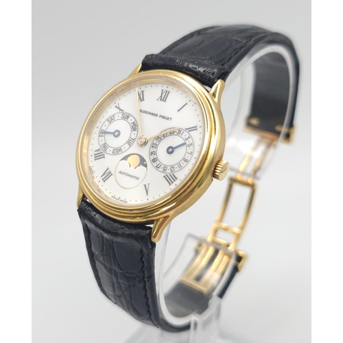 183 - An Audemars Piguet 18K Gold Automatic Moon-Phase Watch. 
Original black leather strap and 18k gold c... 