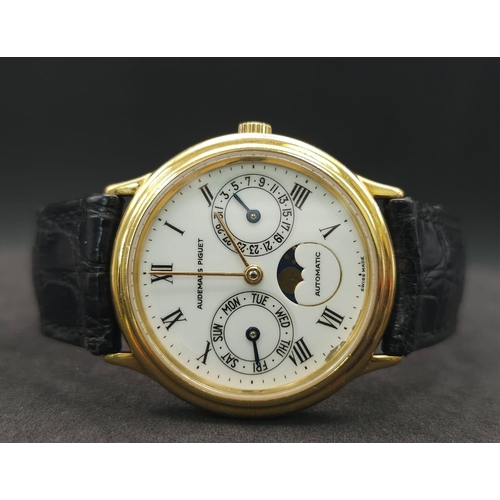 183 - An Audemars Piguet 18K Gold Automatic Moon-Phase Watch. 
Original black leather strap and 18k gold c... 