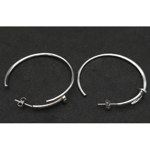 370 - A Pair of 9K White Gold Screw Hoop Earrings in a Cartier Style. 4cm diameter. 9.1g total weight.