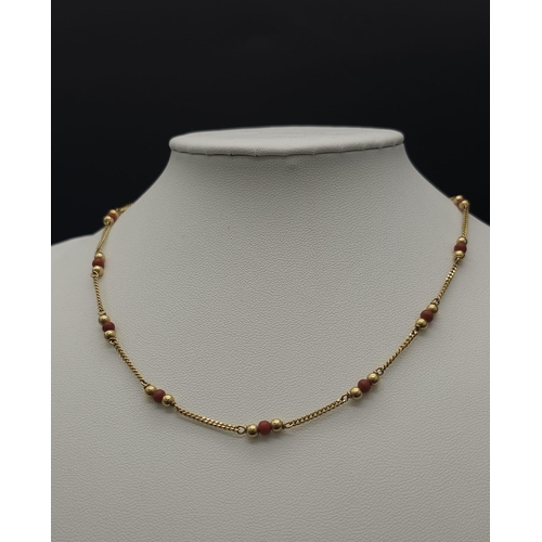 398 - 9kt Yellow Gold Coral Set Necklace.
W: 5.1g
L: 37cm