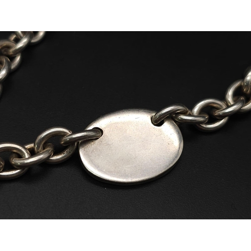 533 - A Sterling silver chunky belcher chain with oval ID tag and t-bar fastening. 57.9g weight. 42cm.