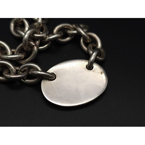 533 - A Sterling silver chunky belcher chain with oval ID tag and t-bar fastening. 57.9g weight. 42cm.