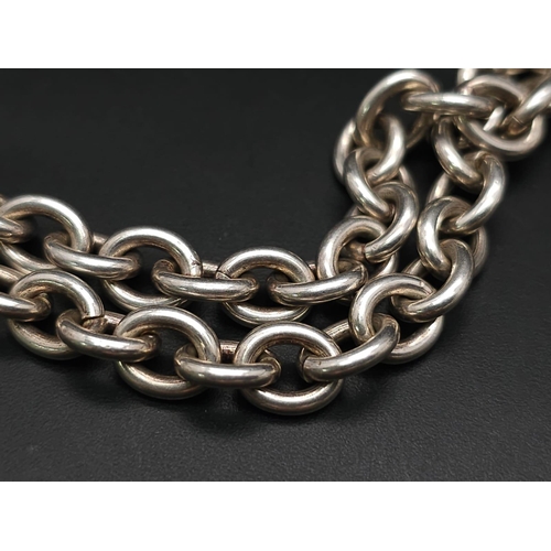 533 - A Sterling silver chunky belcher chain with oval ID tag and t-bar fastening. 57.9g weight. 42cm.