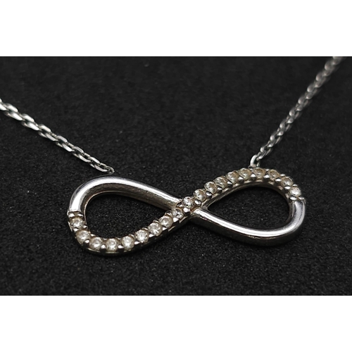 664 - 14K WHITE GOLD DIAMOND SET INFINITY NECKLACE. TOTAL WEIGHT 2.1G. TOTAL LENGTH 44CM.