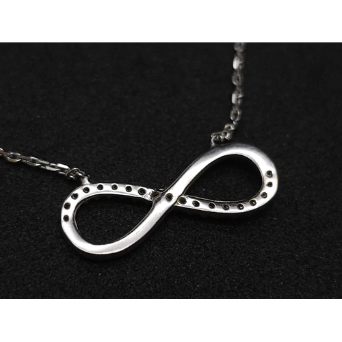 664 - 14K WHITE GOLD DIAMOND SET INFINITY NECKLACE. TOTAL WEIGHT 2.1G. TOTAL LENGTH 44CM.