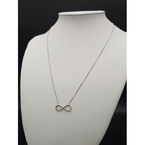 664 - 14K WHITE GOLD DIAMOND SET INFINITY NECKLACE. TOTAL WEIGHT 2.1G. TOTAL LENGTH 44CM.