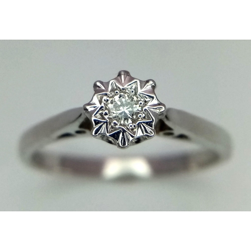 491 - A 9k white gold diamond solitaire illusion set ring. 2.2g total weight. Size N (dia:0.10ct)