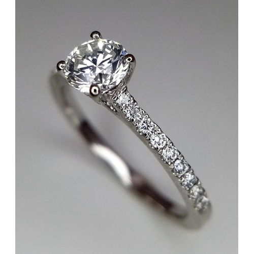 514 - A 950 Platinum Diamond Ring. Brilliant round cut central SI2 diamond - 0.53ct. 0.17ctw diamonds on s... 