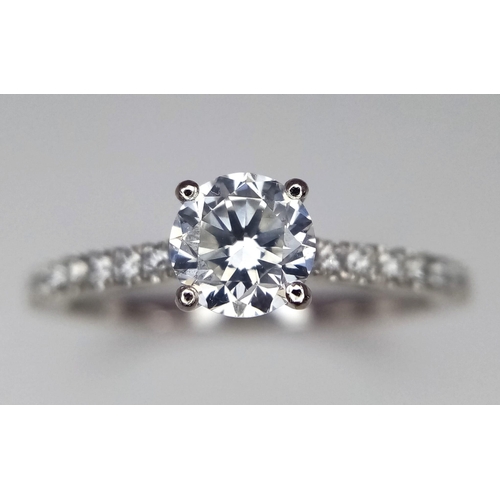 514 - A 950 Platinum Diamond Ring. Brilliant round cut central SI2 diamond - 0.53ct. 0.17ctw diamonds on s... 